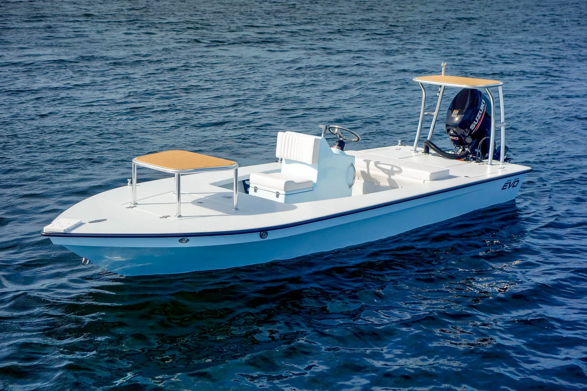 Three-quarter view at rest. Center console, T-top shade, the 18-foot deck with a 6 foot 7 inch beam.