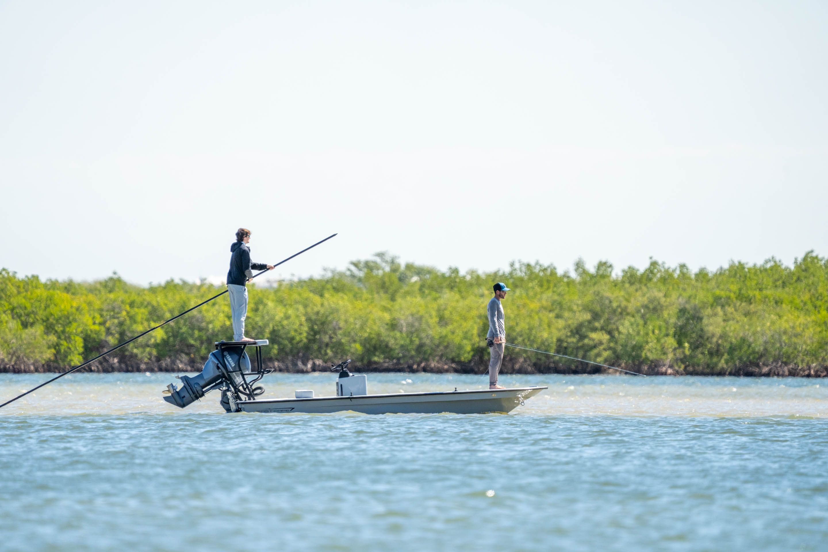 Guide poling an East Cape skiff on the flats