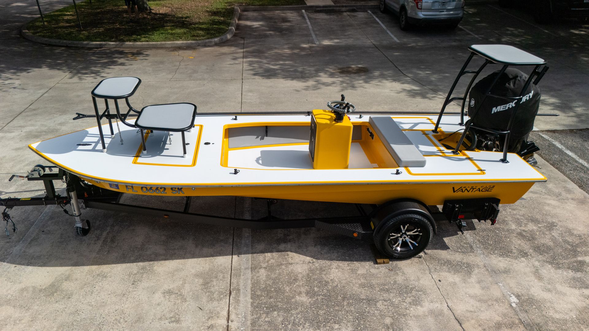 A yellow East Cape Vantage on its trailer outside the shop