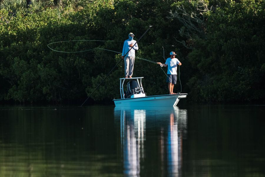 Tanner on the poling platform while a client casts a fly from the bow