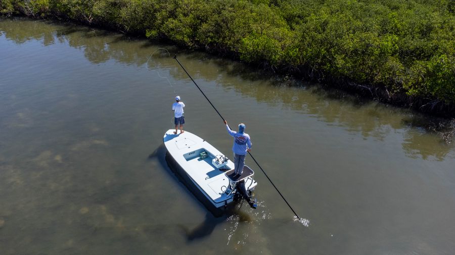 Drone view of the skiff being poled through shallow water